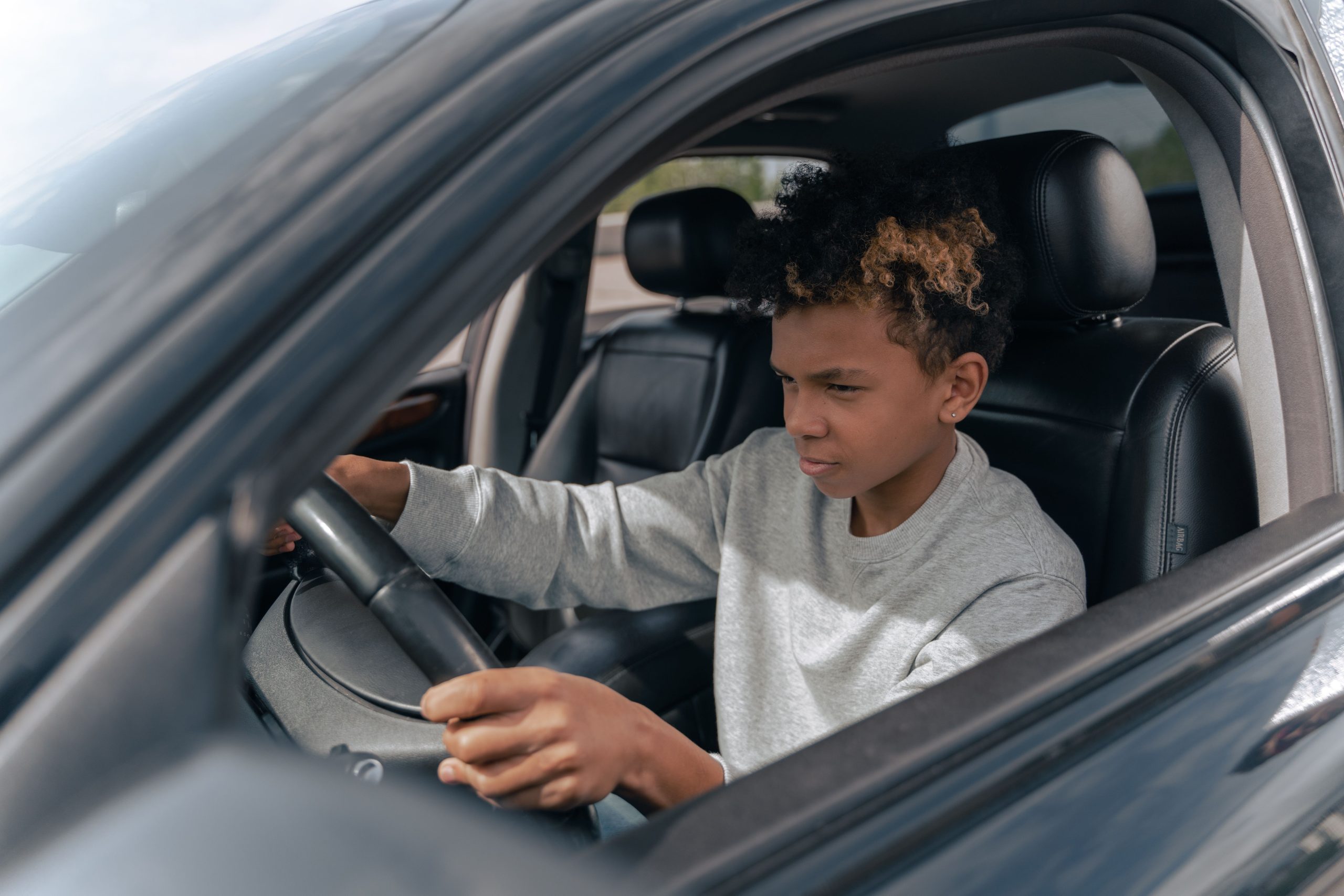 Jeune garçon apprenant à conduire avec attention